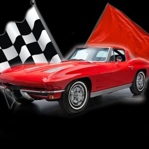 Red 1963 Chevrolet Corvette Sting Ray with a checkered flag and a red flag.