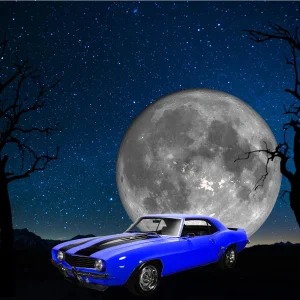 Blue 1969 Chevrolet Camaro Z28 under a full moon and starry sky.
