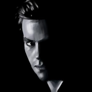 Black and white portrait of a man half in shadow.