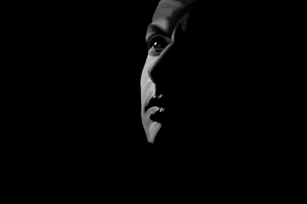 Black and white portrait of a man in profile emerging from shadow.